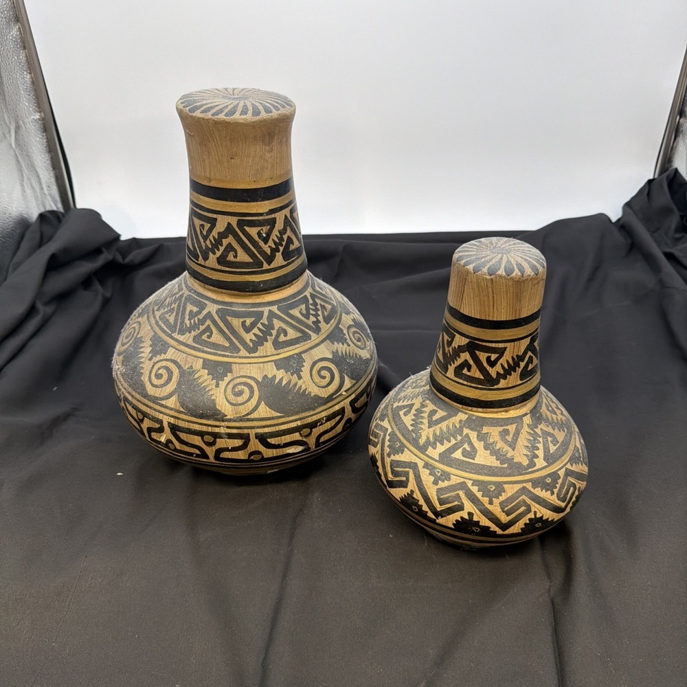vintage, handmade Mexican pottery water jugs, often featuring Aztec